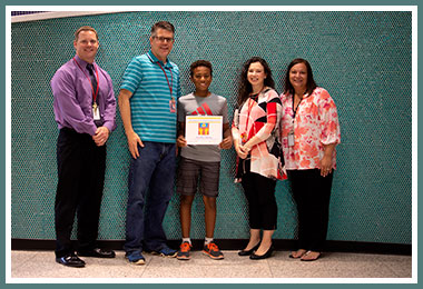Christian with Vice Principal Edwards, fifth grade teacher Mr. Ivanusic, Principal Batis, and Jennifer Squeglia
