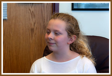 Sydney in Dr Rowe's office, getting news of the Elijah Award!
