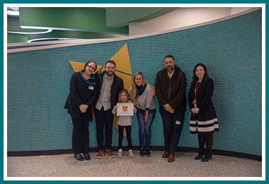 Olivia with Jen Straw, parents Brock and Kelly, Tom Straw, and Principal Batis

