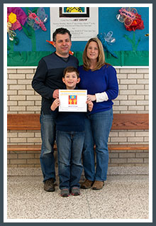 Altai with his award certificate and proud parents Mustafa & Miranda