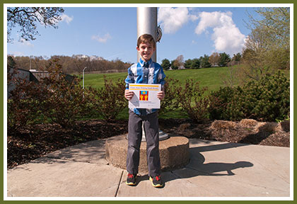 Clay Sauereisen holding his Elijah Straw Helping Hand Award