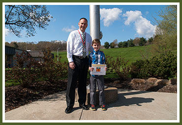 Clay with O'Hara Elementary Principal Dr. Mike Rowe